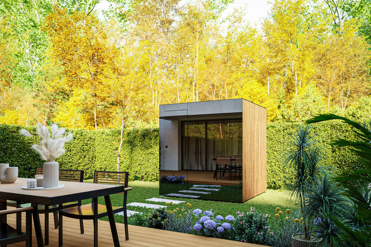 Thermasol outdoor sauna with glass front and wood-clad side, garden setting