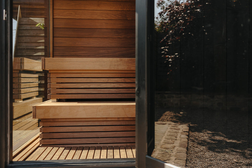 Thermasol Nordic Misty sauna interior, aspen benches seen through the glass door