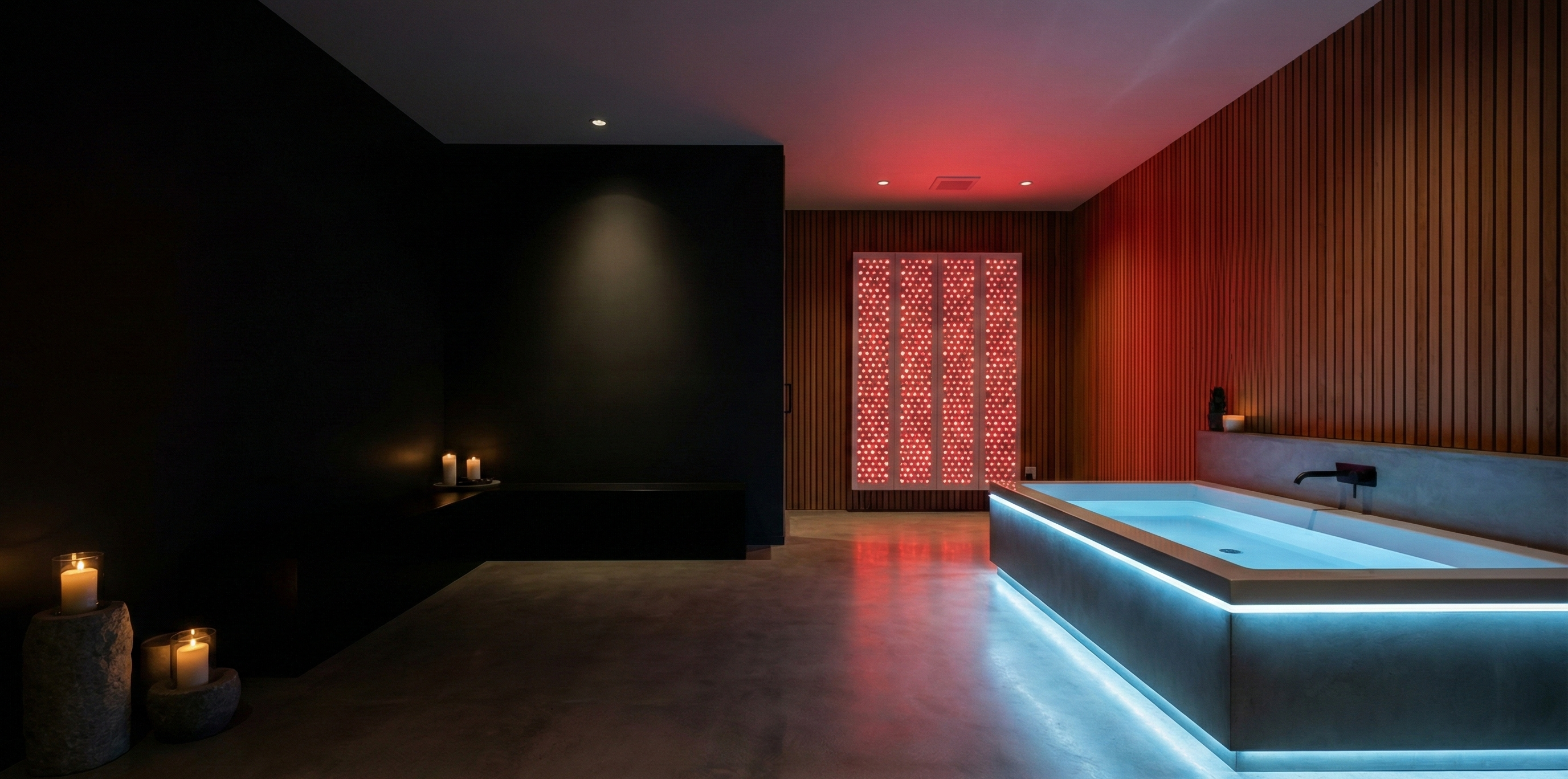 Modern indoor spa with illuminated bathtub and red wall lights