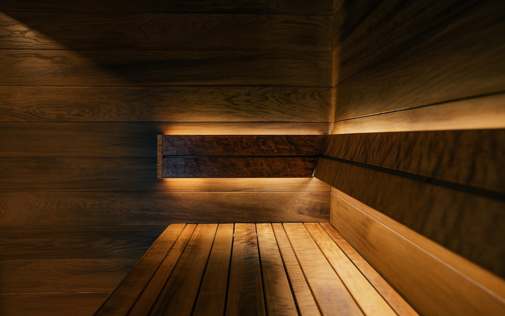 Luxury dark sauna with warm amber lighting