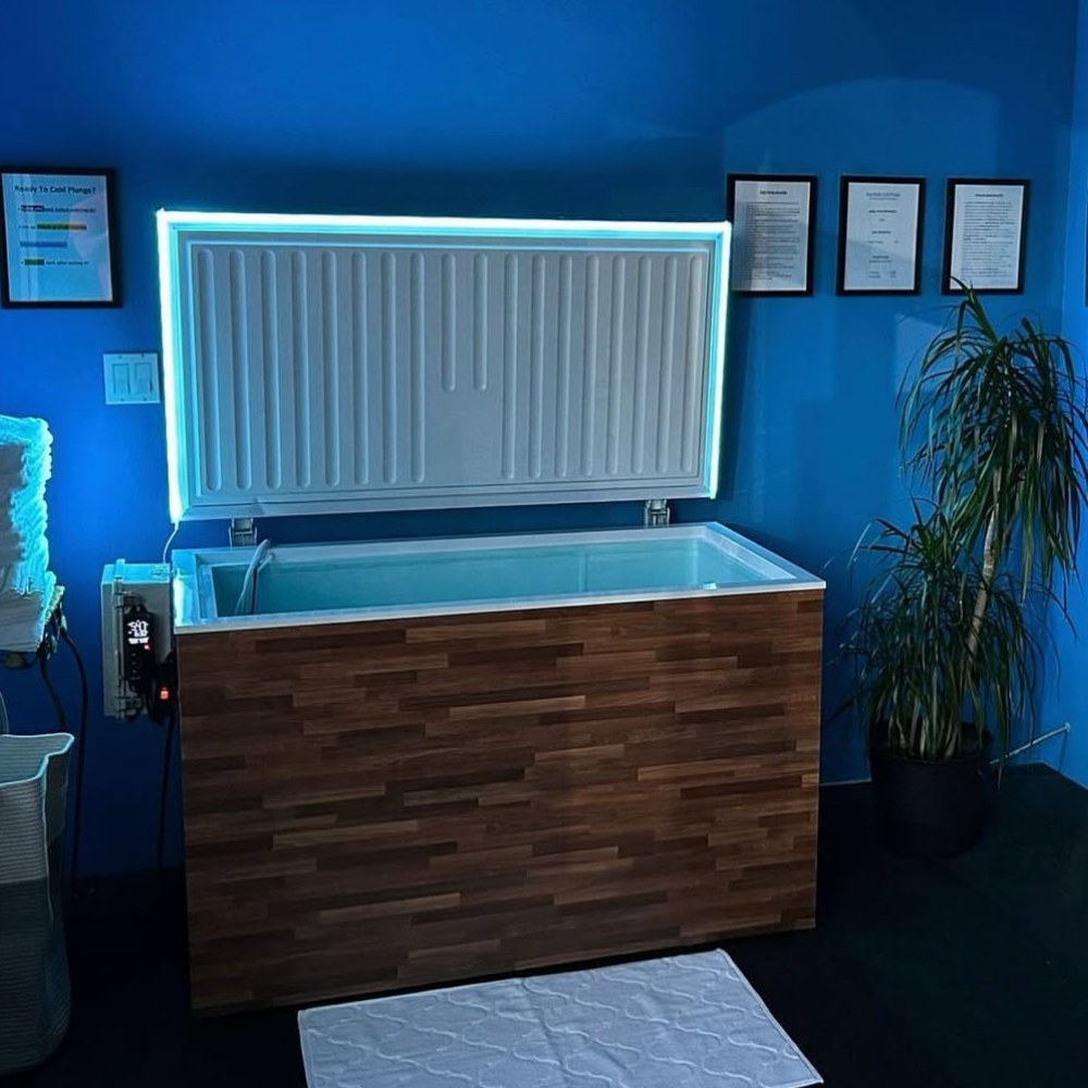 Plunge Zero Commercial in Walnut with its cover open in a spa.