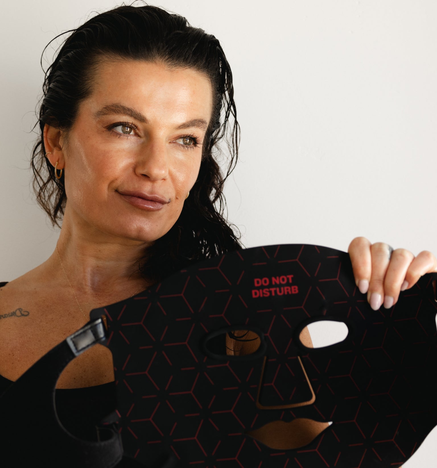 Woman holding the Renew Red Light Mask