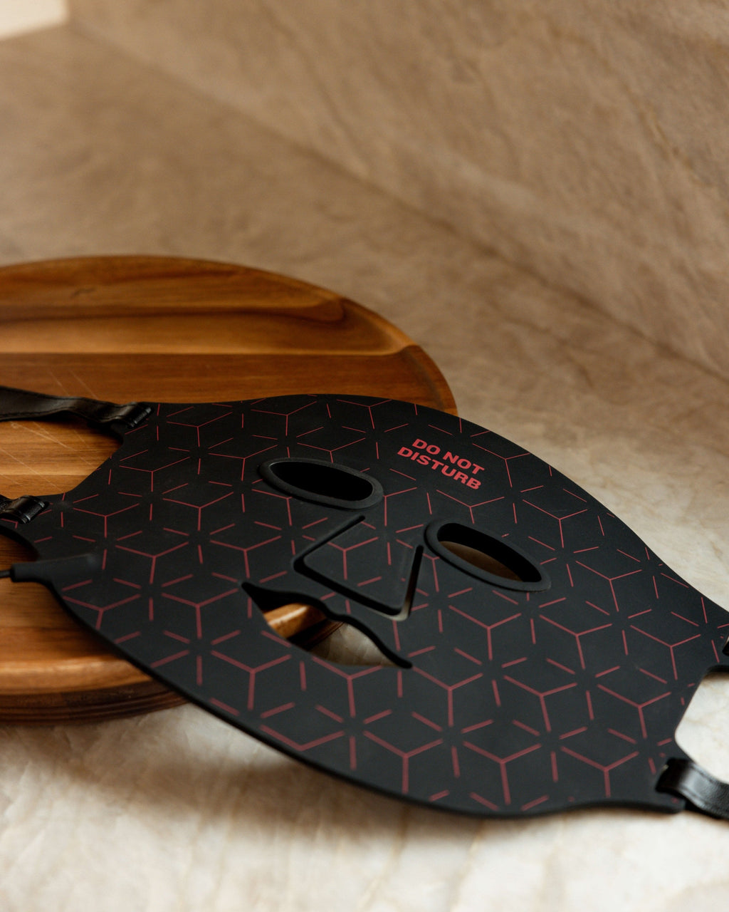 Renew Red Light Mask and controller arranged on a wood tray