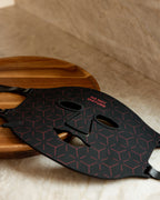 Renew Red Light Mask and controller arranged on a wood tray