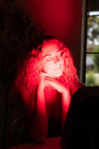 Woman seated in front of the illuminated Renew Small Panel