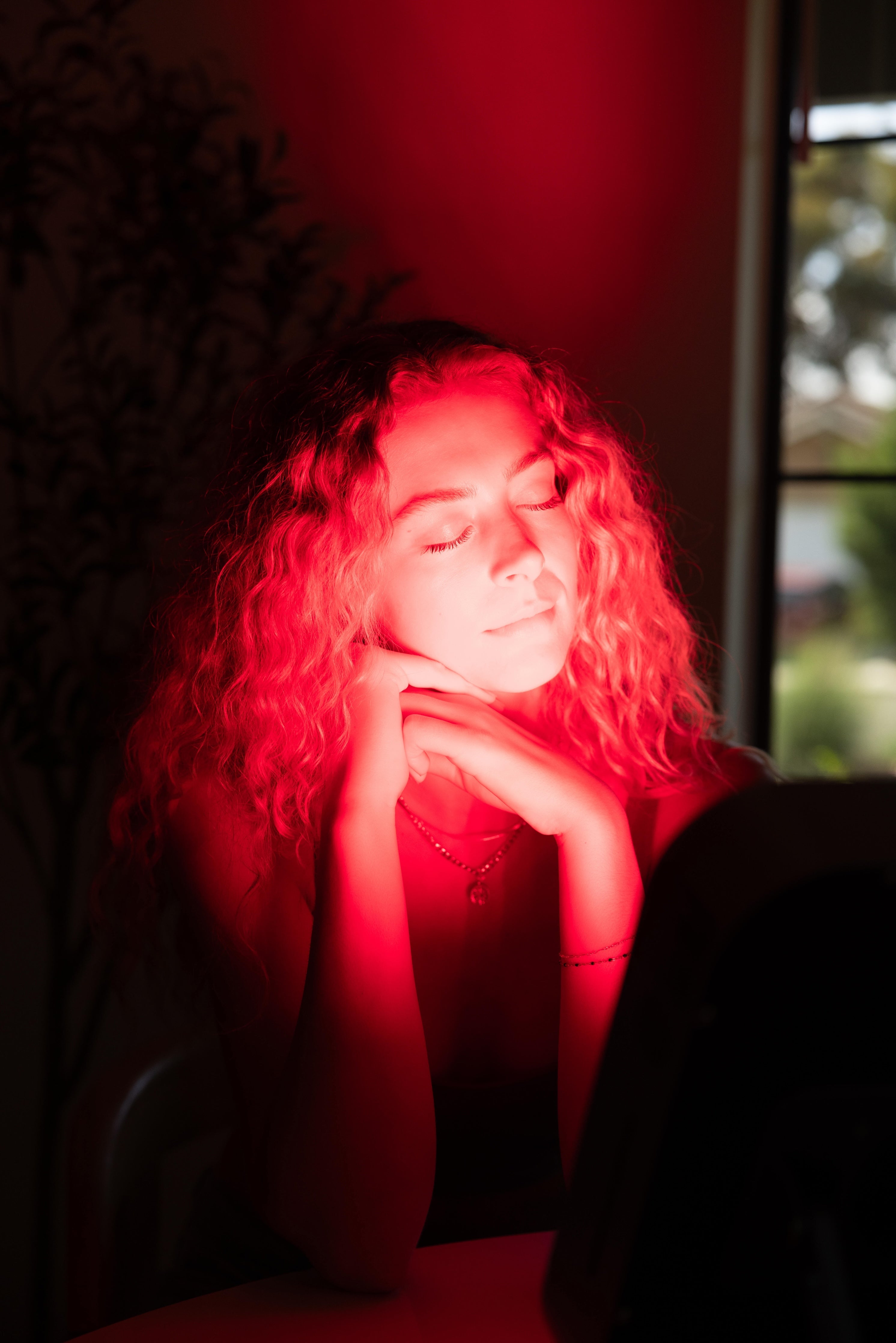 Woman seated in front of the illuminated Renew Small Panel