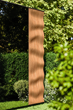 Close-up of the Thermasol Ombra wave-profile IPE wood panel beside the tinted glass wall