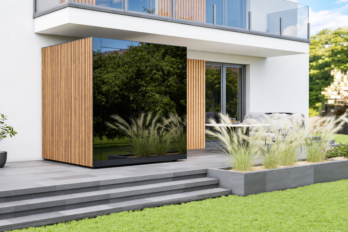 Thermasol Spectra outdoor sauna with a dark glass front and vertical wood cladding beside a home terrace
