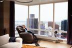 Infinity Smart Chair X3 reclined in a penthouse living room