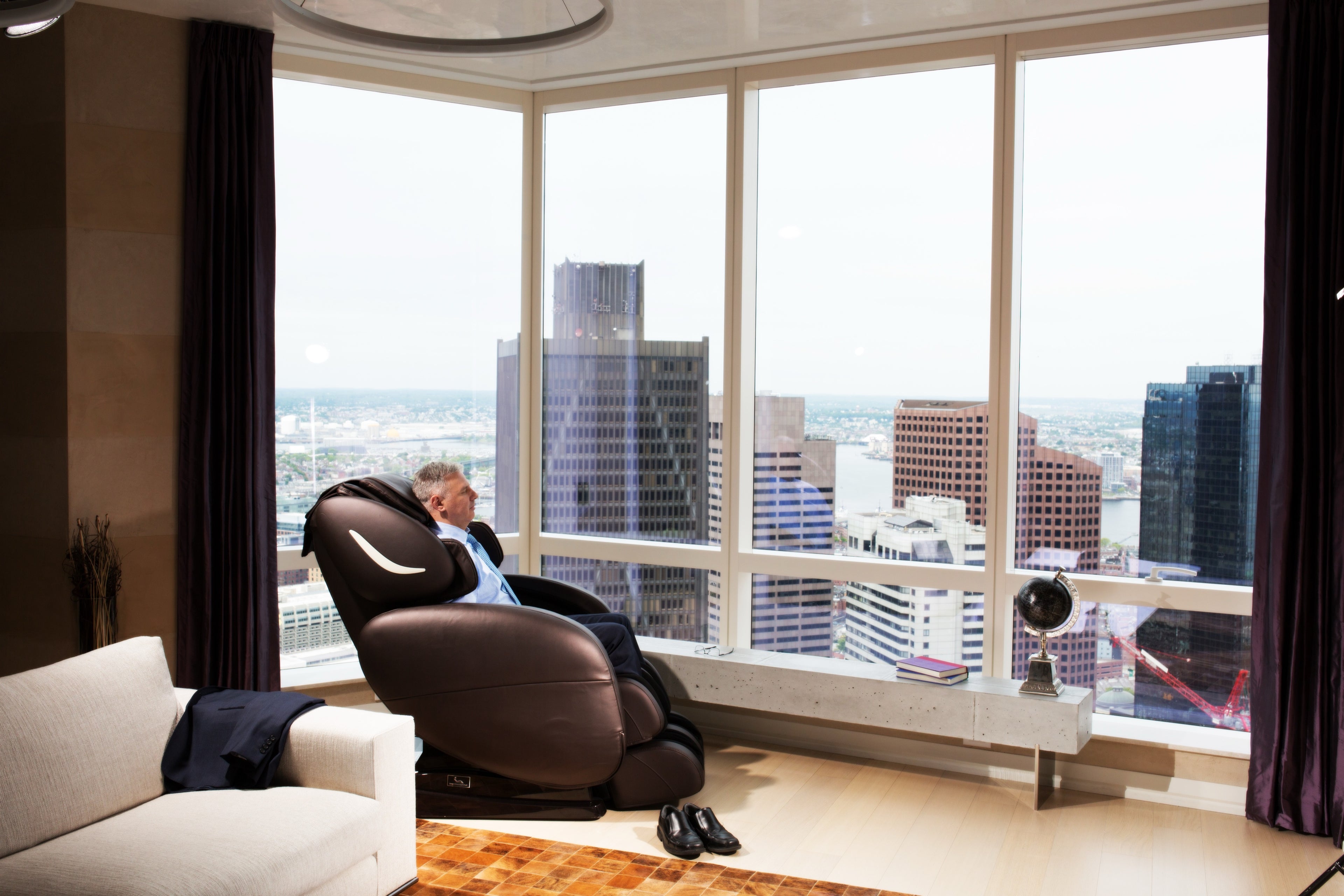 Infinity Smart Chair X3 reclined in a penthouse living room